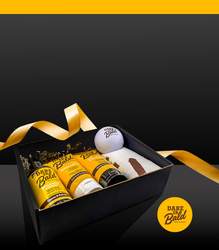 Gift set with 'Dare to be Bald' products in a black box on a dark background.